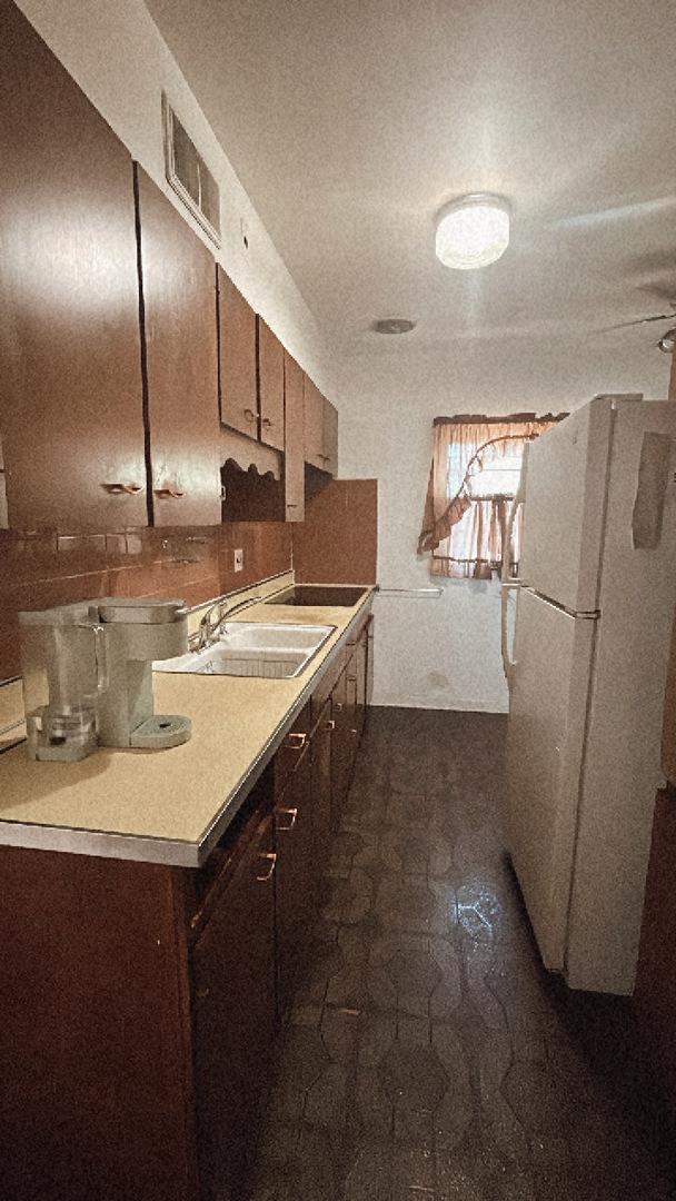 11138 Shaw St, Westchester, IL 60154 - kitchen featuring freestanding refrigerator, light countertops, and a sink