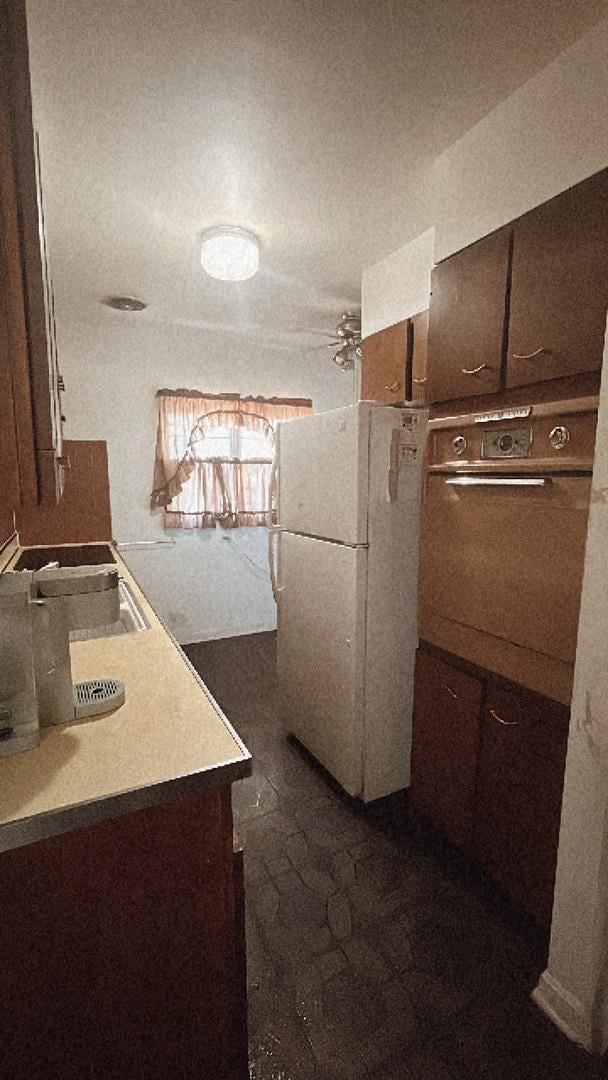 11138 Shaw St, Westchester, IL 60154 - kitchen featuring freestanding refrigerator, wall oven, and dark brown cabinetry