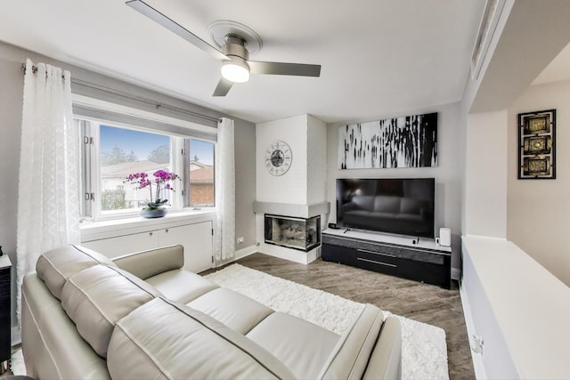 5004 N Knight Ave, Norridge, IL 60706 - living room with wood finished floors, ceiling fan, baseboards, and a multi sided fireplace