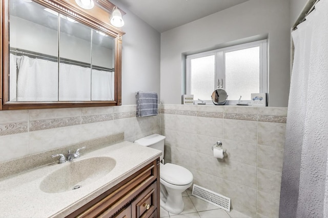 5004 N Knight Ave, Norridge, IL 60706 - full bath featuring tile walls, toilet, vanity, tile patterned flooring, and wainscoting