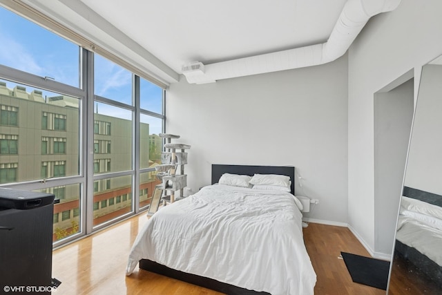 1000 W Leland Ave Unit 5C, Chicago, IL 60640 - bedroom featuring wood finished floors and baseboards