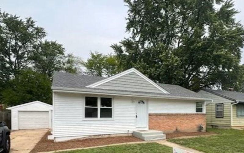 1112 Drexel Blvd, Machesney Park, IL 61115 - single story home featuring an outbuilding, a front yard, brick siding, driveway, and a garage