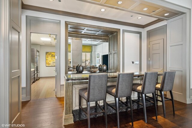2550 N Lakeview Ave Unit N903, Chicago, IL 60614 - kitchen featuring ornamental molding, a breakfast bar, dark wood finished floors, recessed lighting, and coffered ceiling