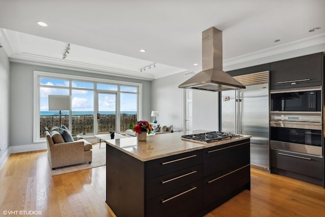 2550 N Lakeview Ave Unit N903, Chicago, IL 60614 - kitchen with built in appliances, island exhaust hood, ornamental molding, dark cabinets, and modern cabinets