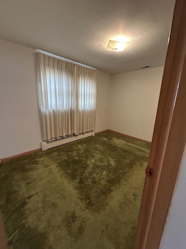 7140 W 64th St, Chicago, IL 60638 - empty room featuring baseboard heating, carpet flooring, and baseboards