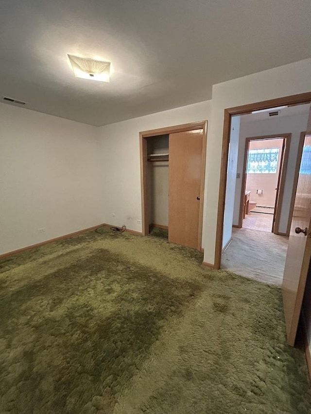 7140 W 64th St, Chicago, IL 60638 - unfurnished bedroom featuring light colored carpet, baseboards, a closet, and baseboard heating