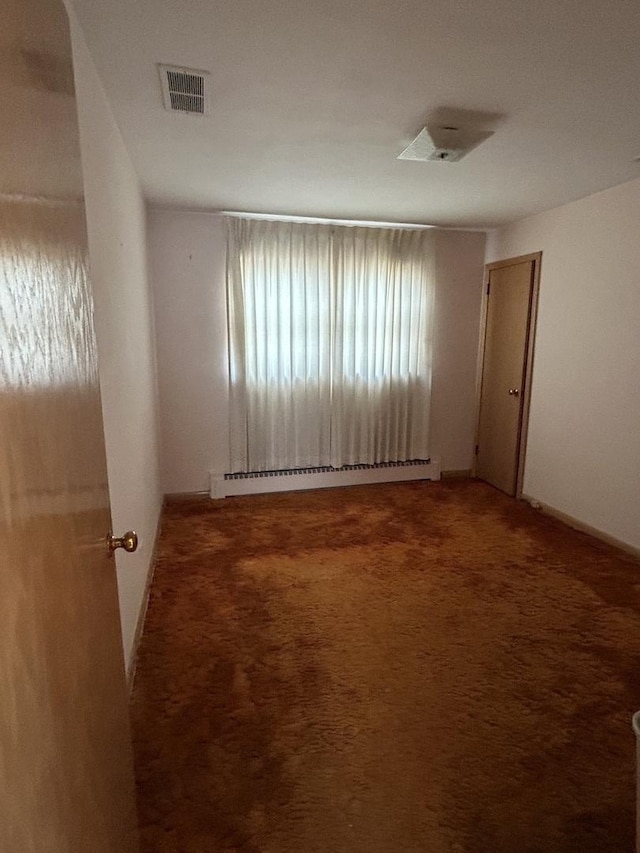 7140 W 64th St, Chicago, IL 60638 - unfurnished room with baseboard heating and carpet flooring