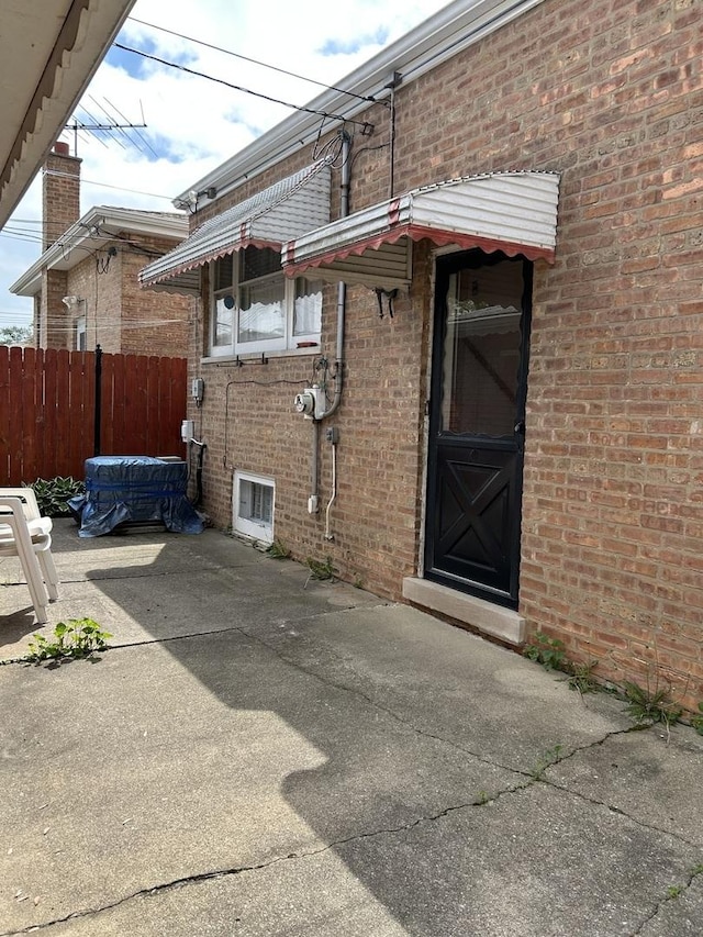7140 W 64th St, Chicago, IL 60638 - view of side of property featuring brick siding and a patio area