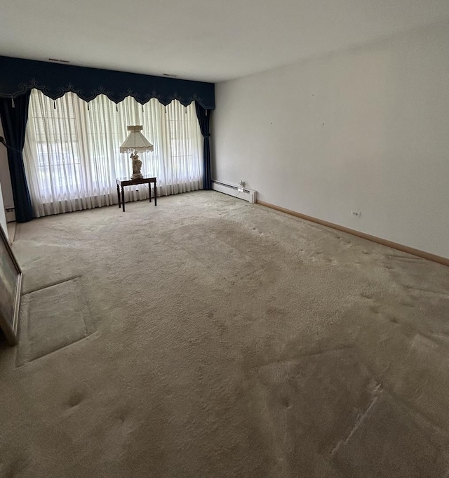7140 W 64th St, Chicago, IL 60638 - carpeted spare room with a baseboard heating unit and baseboards
