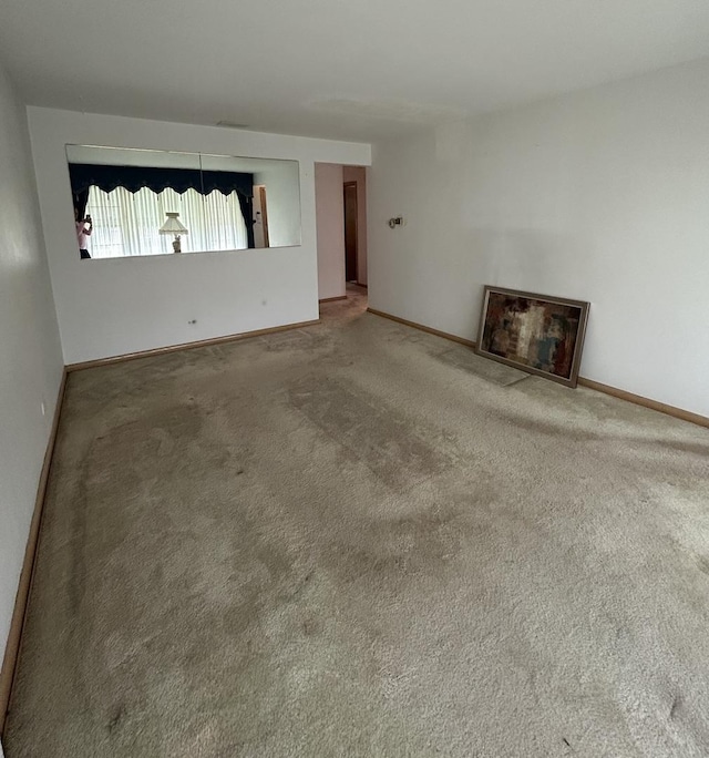 7140 W 64th St, Chicago, IL 60638 - unfurnished living room featuring carpet flooring and baseboards