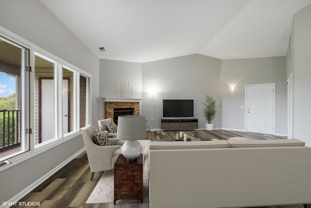 19463 Manchester Dr Unit 2, Mokena, IL 60448 - living area with dark wood-style flooring, plenty of natural light, baseboards, vaulted ceiling, and a brick fireplace