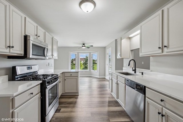 19463 Manchester Dr Unit 2, Mokena, IL 60448 - kitchen featuring appliances with stainless steel finishes, a sink, dark wood-type flooring, ceiling fan, and a peninsula