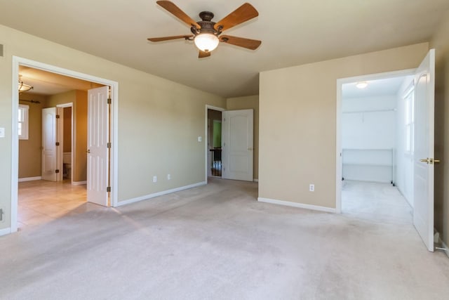 230 S Constitution Dr, Aurora, IL 60506 - unfurnished bedroom with carpet flooring, baseboards, a walk in closet, and a ceiling fan
