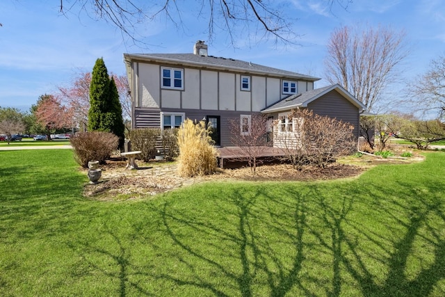 230 S Constitution Dr, Aurora, IL 60506 - back of property with board and batten siding, a wooden deck, a yard, and a chimney