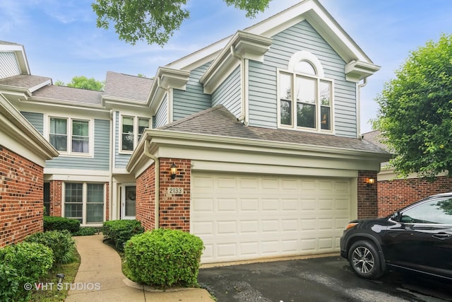 2133 Coldspring Rd, Arlington Heights, IL 60004 - view of front facade featuring brick siding, asphalt driveway, and roof with shingles