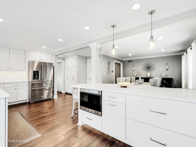 1465 Cantigny Way, Wheaton, IL 60189 - kitchen with high end refrigerator, light countertops, ornamental molding, recessed lighting, and white cabinets