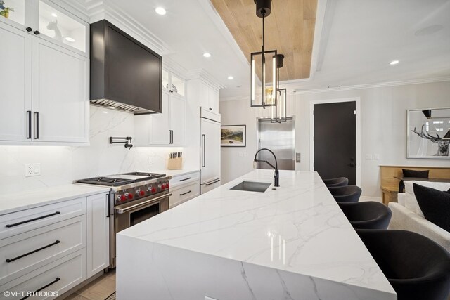 1543 N Wieland St Ph-N, Ph-N Chicago, IL 60610 - kitchen featuring a sink, premium appliances, wall chimney range hood, ornamental molding, and decorative backsplash