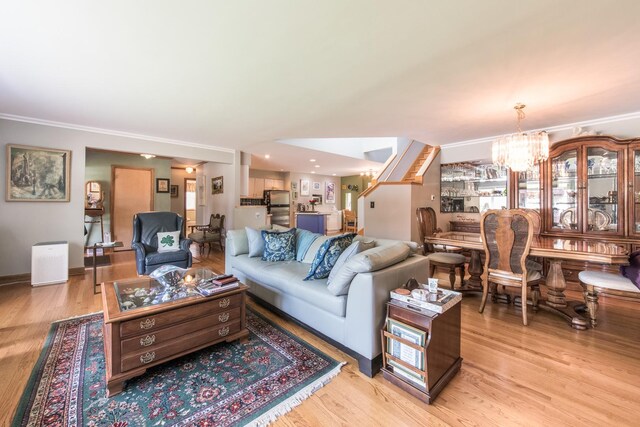 228 Cornell Ave, Des Plaines, IL 60016 - living room with a chandelier, light wood finished floors, ornamental molding, and baseboards