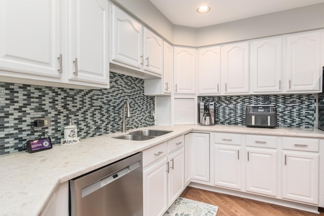 228 Cornell Ave, Des Plaines, IL 60016 - kitchen with stainless steel dishwasher, a sink, white cabinets, backsplash, and light wood-style floors