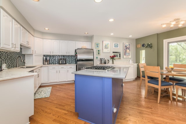 228 Cornell Ave, Des Plaines, IL 60016 - kitchen featuring appliances with stainless steel finishes, a sink, light countertops, decorative backsplash, and recessed lighting