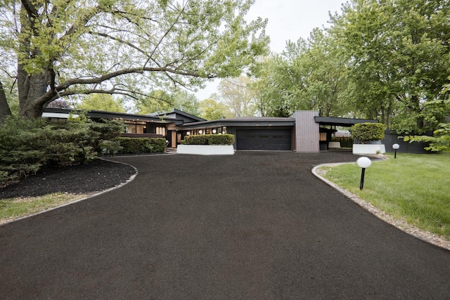 221 N Dale Ave, Mount Prospect, IL 60056 - view of front facade with an attached garage, asphalt driveway, and a front lawn