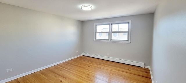1353 Perry St Unit 6, Des Plaines, IL 60016 - empty room with a baseboard radiator, light wood finished floors, and baseboards
