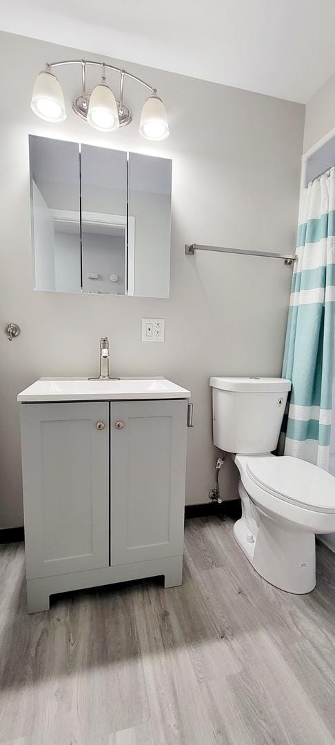1353 Perry St Unit 6, Des Plaines, IL 60016 - full bath with wood finished floors, vanity, and toilet