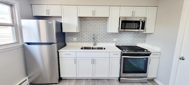 1353 Perry St Unit 6, Des Plaines, IL 60016 - kitchen featuring stainless steel appliances, a sink, light countertops, and white cabinets