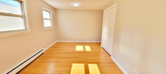 1353 Perry St Unit 6, Des Plaines, IL 60016 - spare room with baseboard heating, light wood finished floors, and baseboards