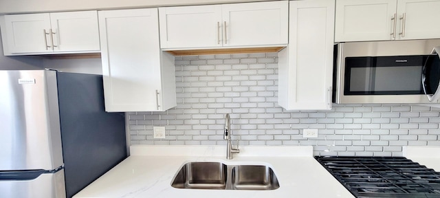 1353 Perry St Unit 6, Des Plaines, IL 60016 - kitchen featuring stainless steel appliances, a sink, light countertops, and white cabinetry