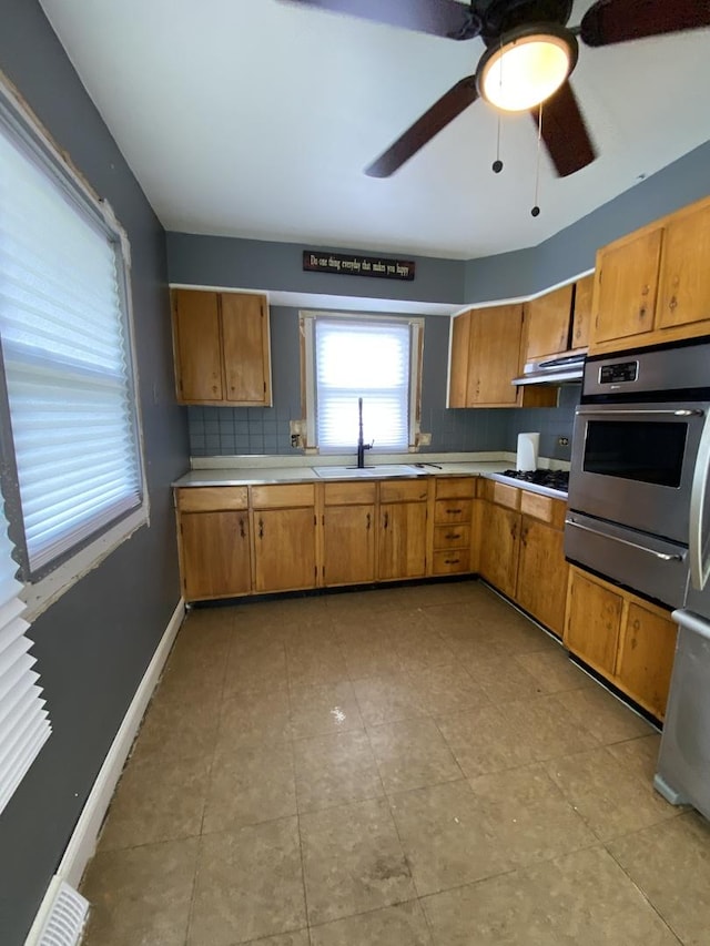 16133 Cambridge Dr, Markham, IL 60428 - kitchen featuring oven, a warming drawer, a sink, light countertops, and under cabinet range hood