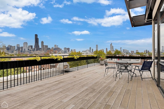 1111 W 14th Pl Unit 211, Chicago, IL 60608 - wooden terrace with a skyline view and outdoor dining space