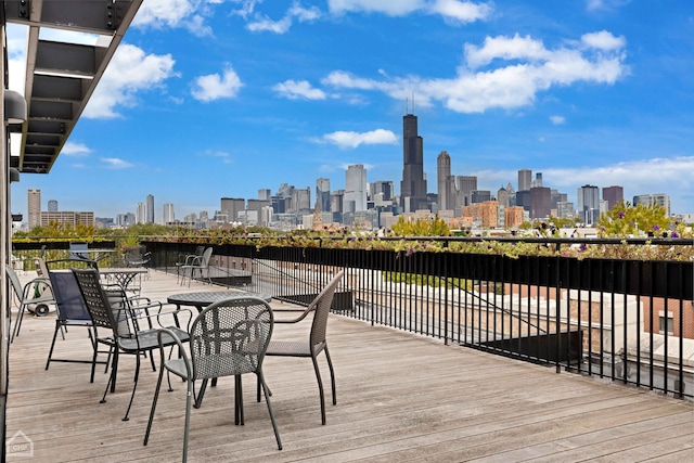 1111 W 14th Pl Unit 211, Chicago, IL 60608 - wooden deck featuring a skyline view and a water view