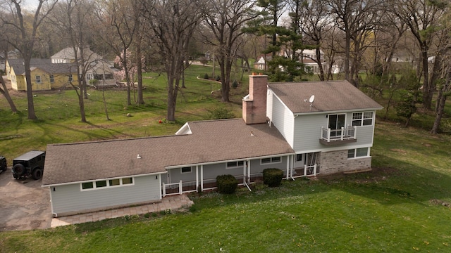 1762 W Palatine Rd, Inverness, IL 60067 - rear view of property with a balcony, a chimney, a yard, and roof with shingles