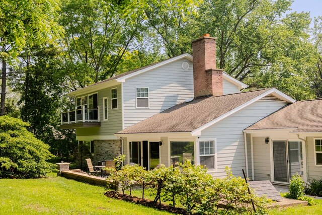 1762 W Palatine Rd, Inverness, IL 60067 - rear view of property featuring a balcony, a yard, a patio, roof with shingles, and a chimney