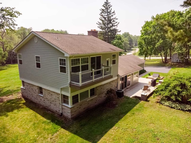 1762 W Palatine Rd, Inverness, IL 60067 - back of property with a chimney, a patio area, a yard, driveway, and roof with shingles