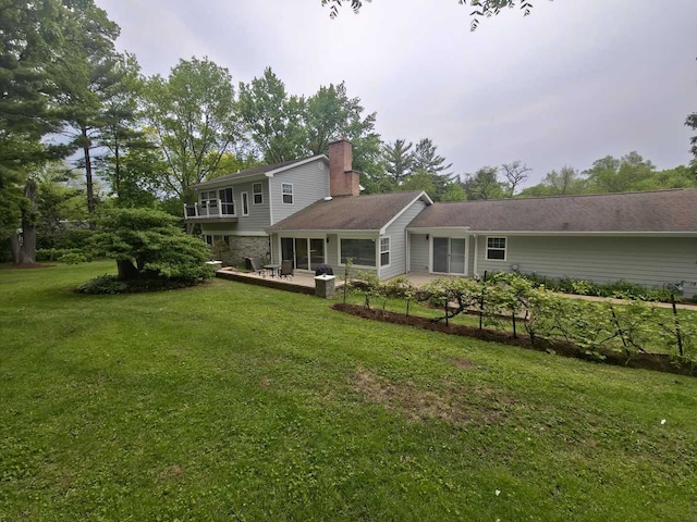 1762 W Palatine Rd, Inverness, IL 60067 - back of house featuring a yard, a chimney, and a patio
