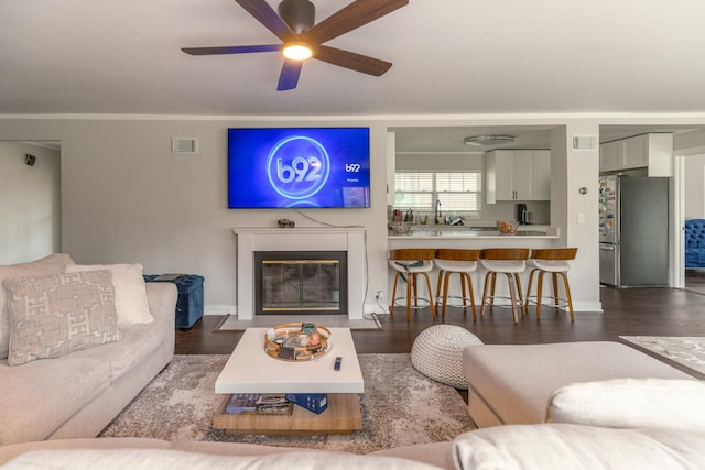 1762 W Palatine Rd, Inverness, IL 60067 - living room with wood finished floors, ceiling fan, a fireplace with flush hearth, and baseboards