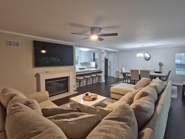 1762 W Palatine Rd, Inverness, IL 60067 - living area with dark wood-style flooring, a ceiling fan, a fireplace with flush hearth, a chandelier, and baseboards