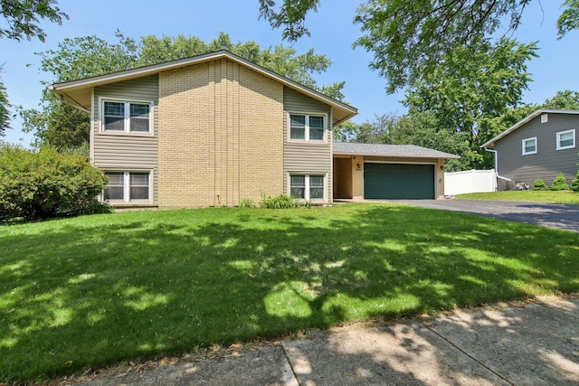 6100 Ridgeway Dr, Woodridge, IL 60517 - view of front of home featuring an attached garage, driveway, a front lawn, and brick siding