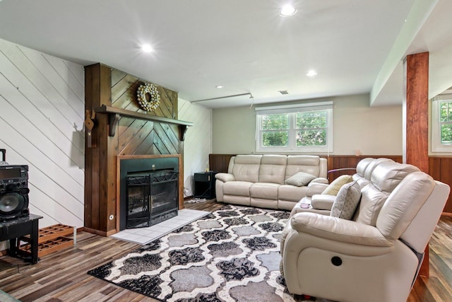 6100 Ridgeway Dr, Woodridge, IL 60517 - living area with wood walls, wood finished floors, a fireplace with flush hearth, and recessed lighting