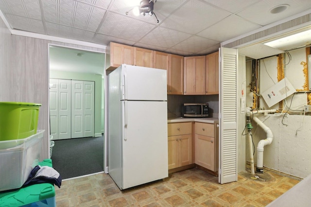 6100 Ridgeway Dr, Woodridge, IL 60517 - kitchen featuring freestanding refrigerator, light flooring, stainless steel microwave, light brown cabinetry, and light countertops
