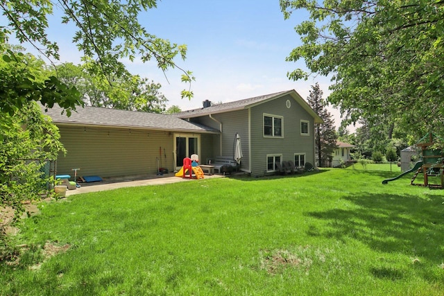 6100 Ridgeway Dr, Woodridge, IL 60517 - rear view of house featuring a playground, a patio, and a lawn