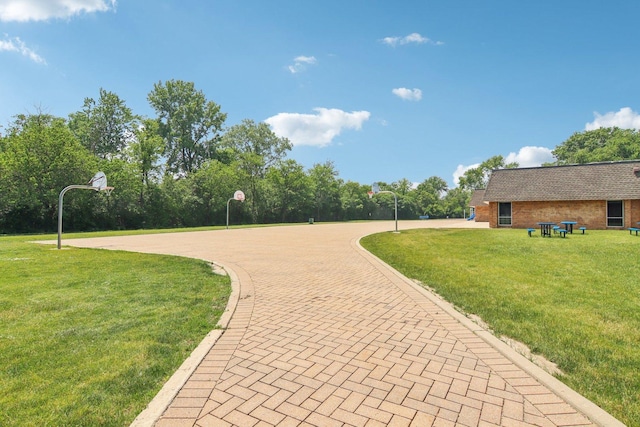 6100 Ridgeway Dr, Woodridge, IL 60517 - view of property's community with a lawn, curved driveway, and community basketball court