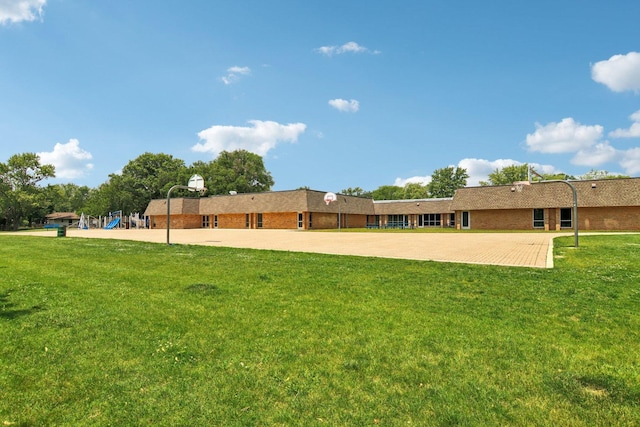 6100 Ridgeway Dr, Woodridge, IL 60517 - back of property with a lawn and community basketball court