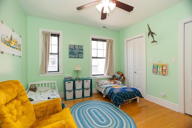 1239 W Jarvis Ave Unit 3, Chicago, IL 60626 - bedroom featuring wood finished floors, a closet, multiple windows, and baseboards