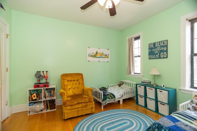 1239 W Jarvis Ave Unit 3, Chicago, IL 60626 - bedroom featuring wood finished floors, multiple windows, and a ceiling fan