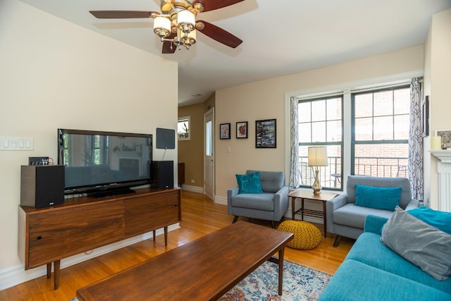 1239 W Jarvis Ave Unit 3, Chicago, IL 60626 - living area featuring wood finished floors, ceiling fan, plenty of natural light, and baseboards