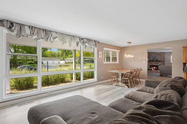 4420 185th Pl, Country Club Hills, IL 60478 - living room featuring a chandelier, plenty of natural light, baseboards, and a brick fireplace
