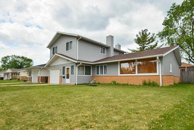 50 Ridgewood Rd, Elk Grove Village, IL 60007 - back of house with brick siding, a chimney, a lawn, and an attached garage